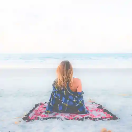 Beautiful lady relaxing in grition summer sandals at the beach
