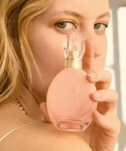 Avon Eve Prive Eau de Parfum – 50ml Shopwice a model holding avon eve prive perfume bottle on shoulder