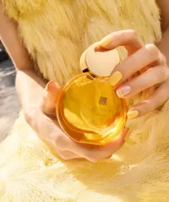 model holding Avon Far Away Shine perfume