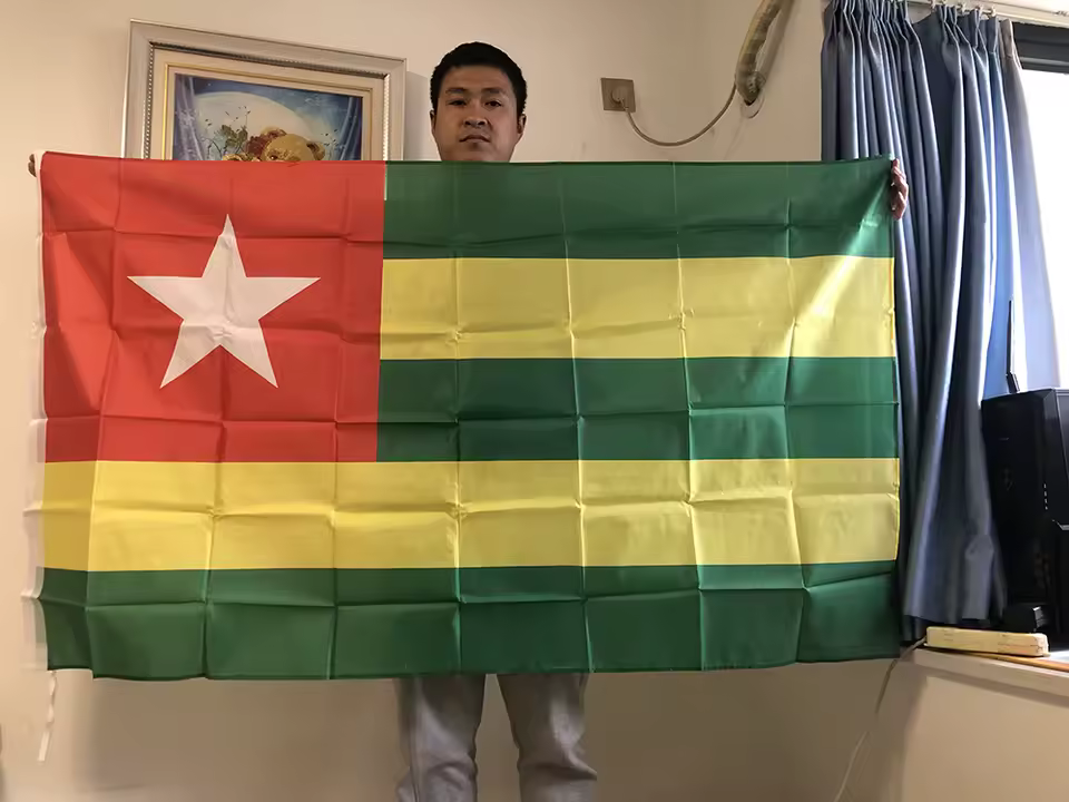 Togo National Flag 90cmx150cm Outdoor Polyester Flag Shopwice Man displaying the Togo nation flag, 90 cm by 150cm